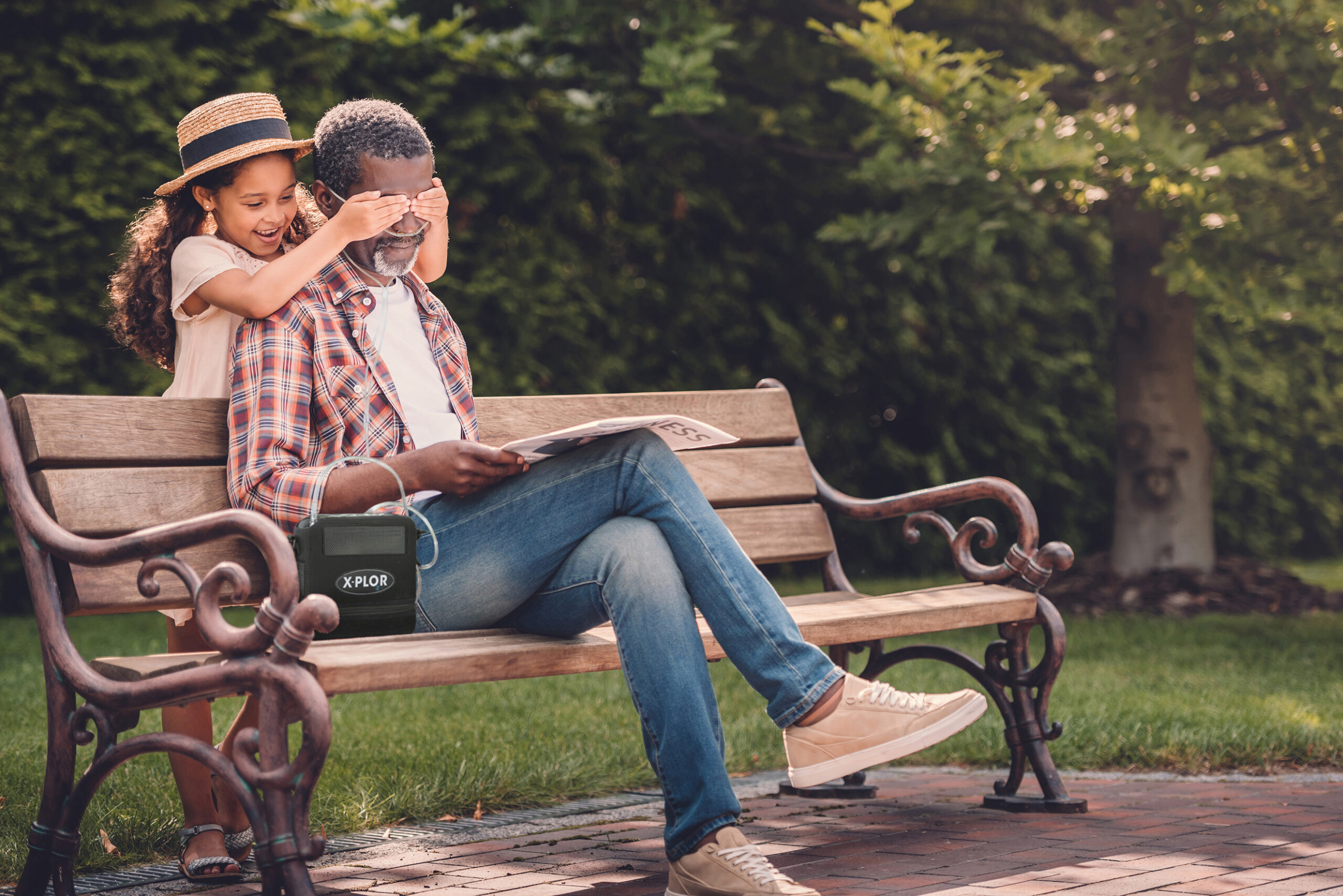 Grandfather and kid playing on park bench.